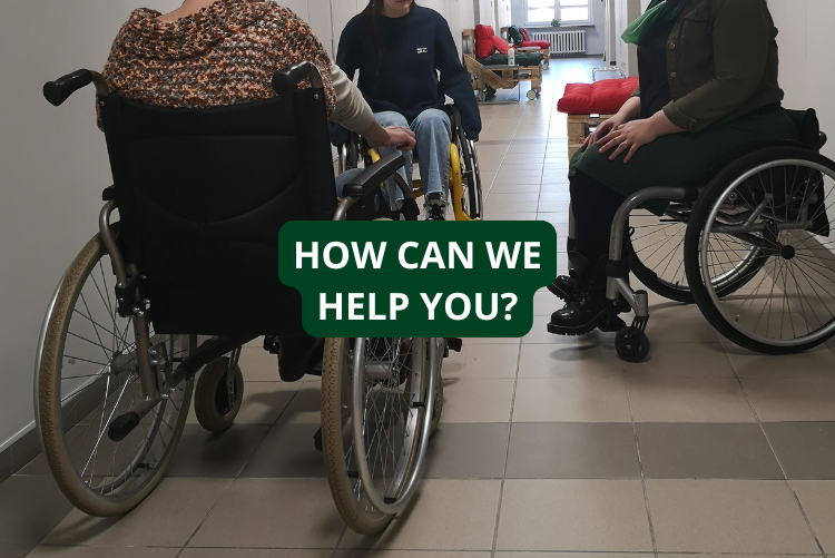 Photo of three wheelchairs, with parts of people visible on them.